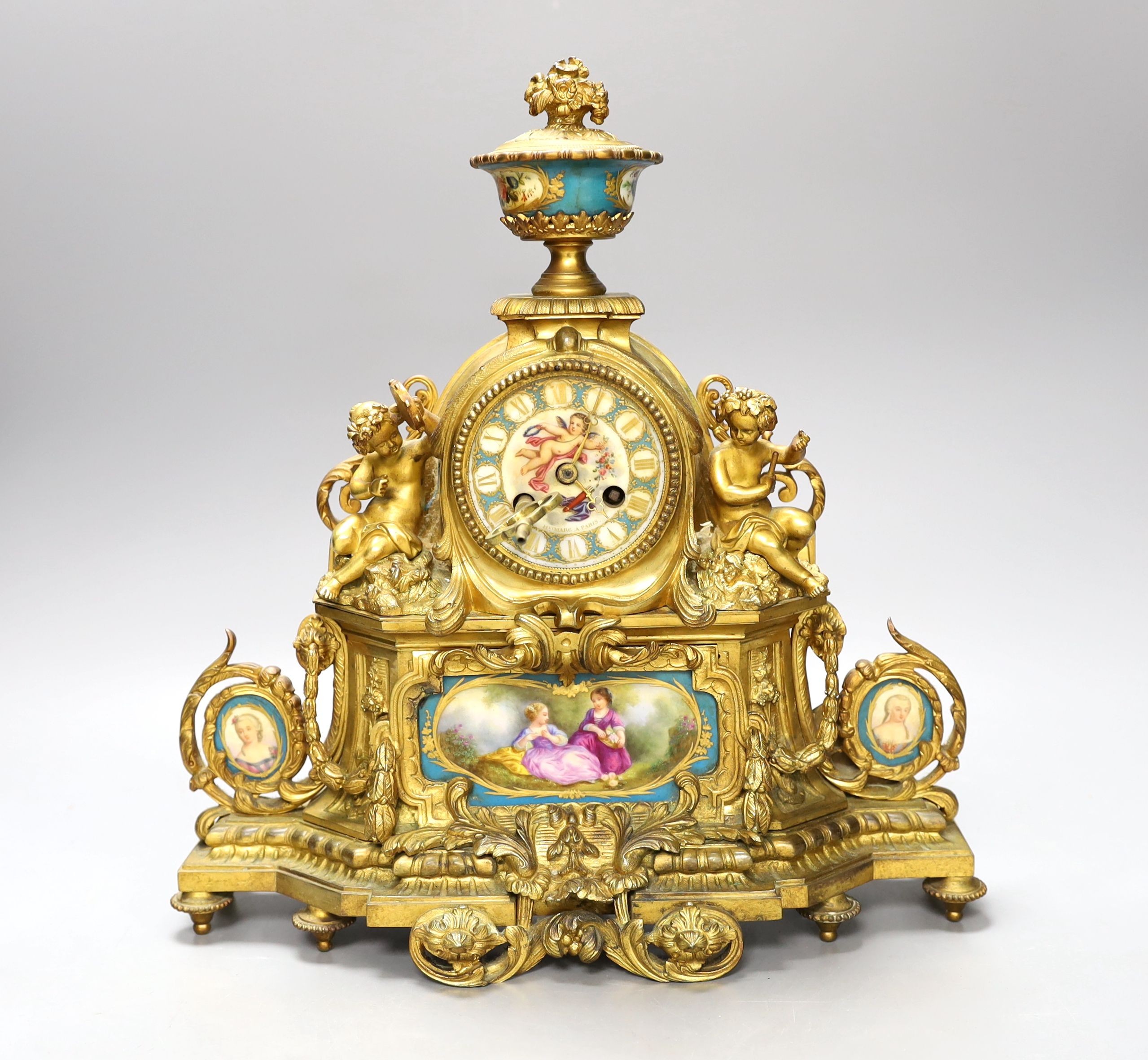 A 19th century French ormolu and Sevres style porcelain mounted mantel clock, with key and pendulum, 35 cm high